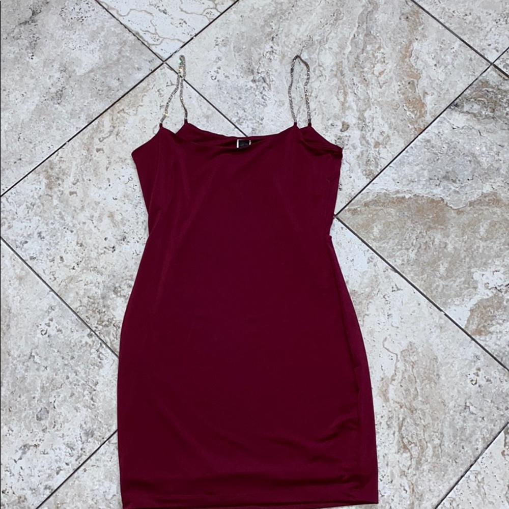 a burgundy dress with rhinestones as straps